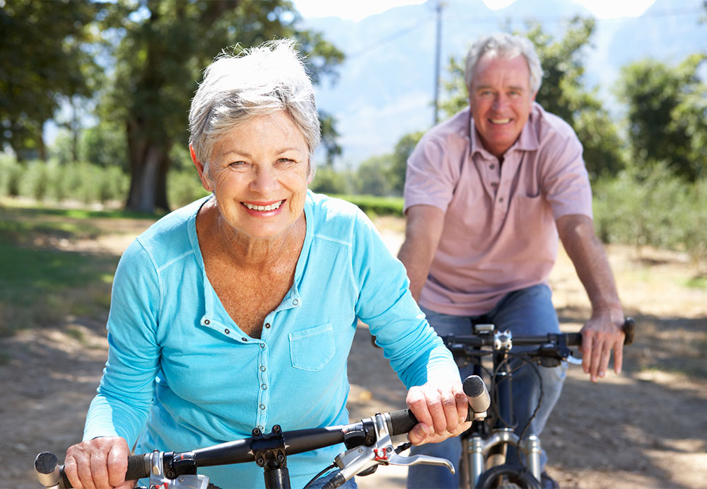 mature woman riding bike with husband